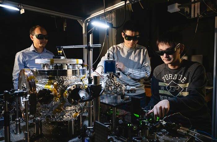 Prof. Tongcang Li (left), Dr. Yuanbin Jin (middle) and Kunhong Shen perform experiments with levitated and rotating fluorescent diamonds at Purdue University.