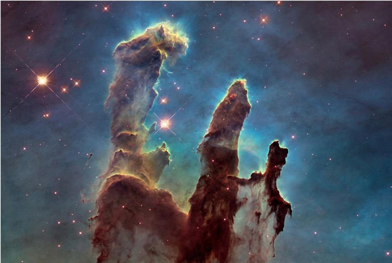 New research proposes a model that determines the universe’s age to be 26.7 billion years, which accounts for the James Webb Space Telescope’s "impossible early galaxy" observations. The telescope captured this Pillars of Creation image last year. 