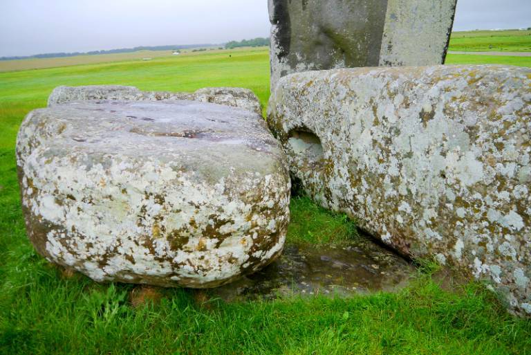 The Altar Stone, seen here underneath two bigger Sarsen stones.