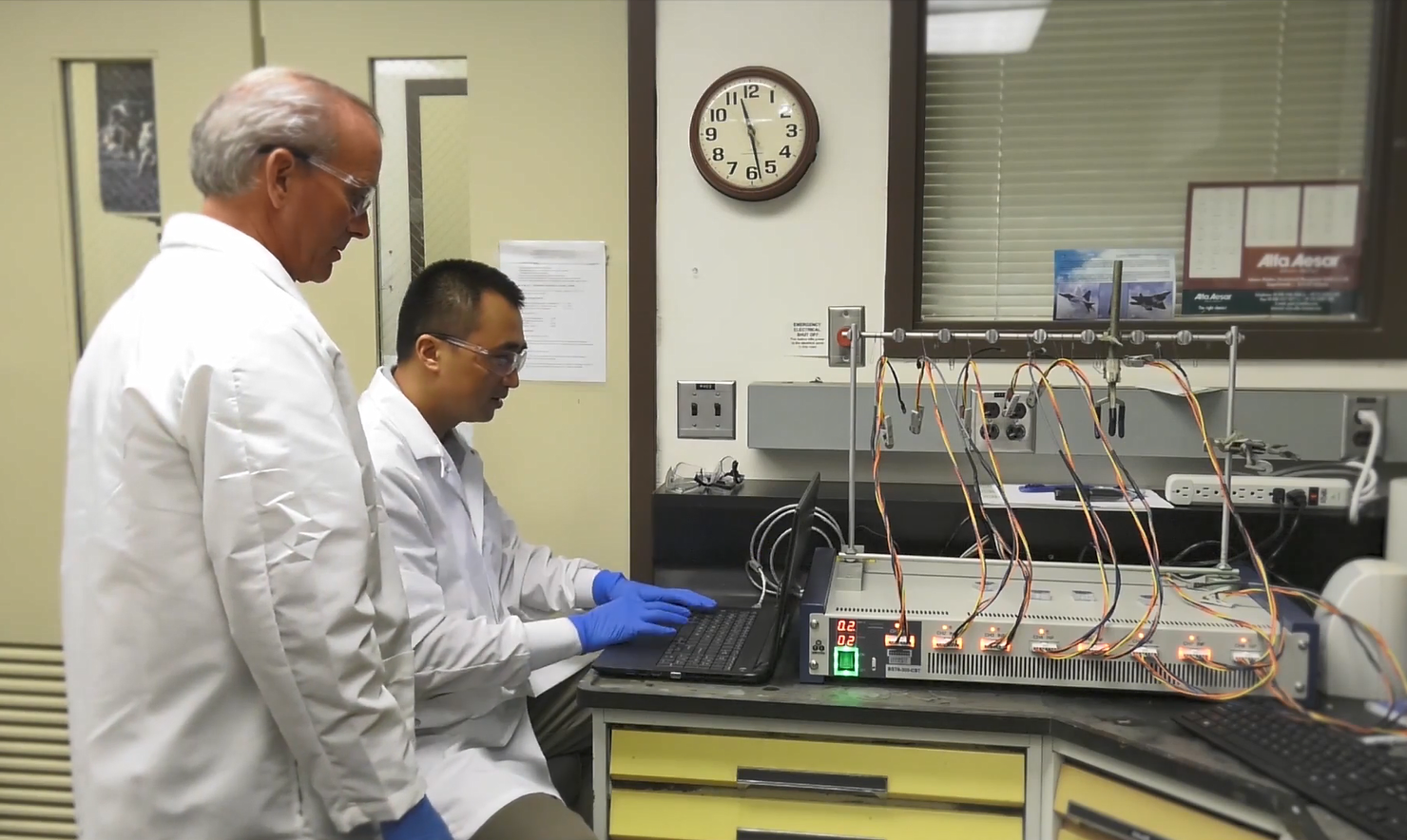 The SABERS activity is developing a solid-state battery for use in aviation applications. In this image, NASA researchers John Connell and Yi Lin (seated) are using a cyclic voltameter to check the performance level of a brand-new cathode the SABERS team created for their solid-state battery. 