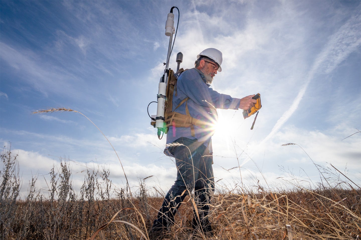 Berkeley Lab scientist Sebastien Biraud leads the field team of researchers looking for lost wells. He carries a backpack-mounted sensor to measure magnetic fields, which can help find the buried metal structure of a well casing.