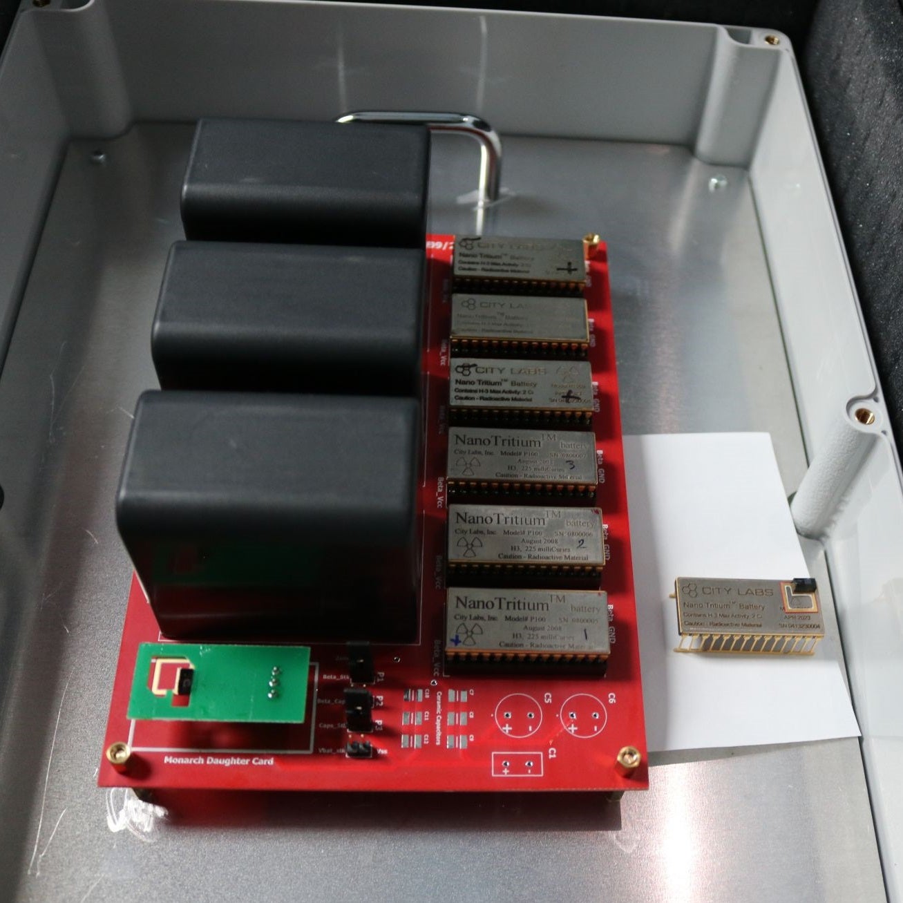 NanoTritium batteries powering a circuit board (left) and a Michigan Micro Mote (right)